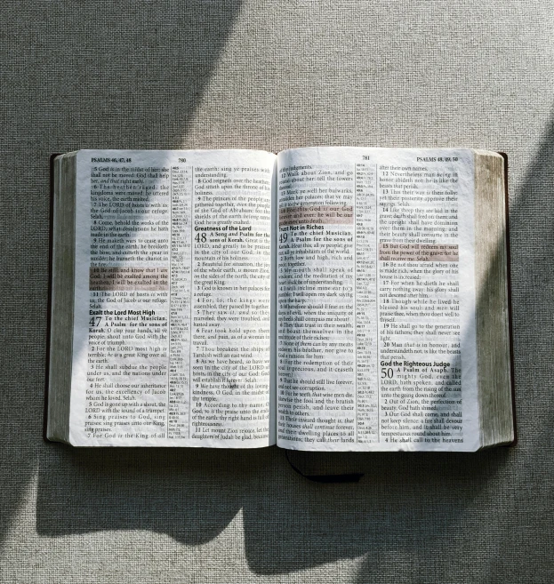 an open book with a table in the background