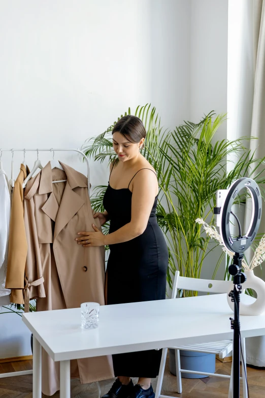 woman in front of a table, working at an ironing board