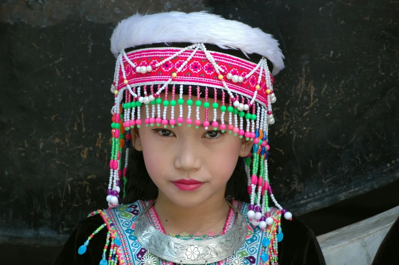 a  with headgear and jewelry on her face