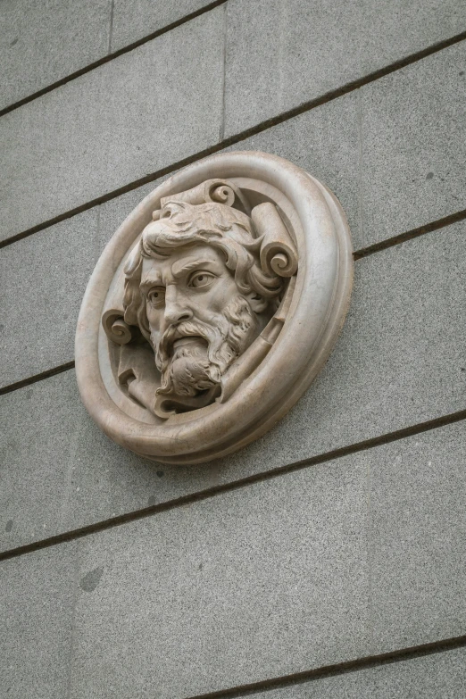 a face is mounted to the side of a building