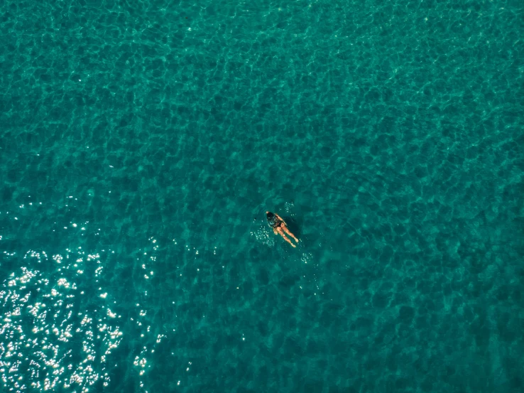 a small boat is seen from above while in the ocean