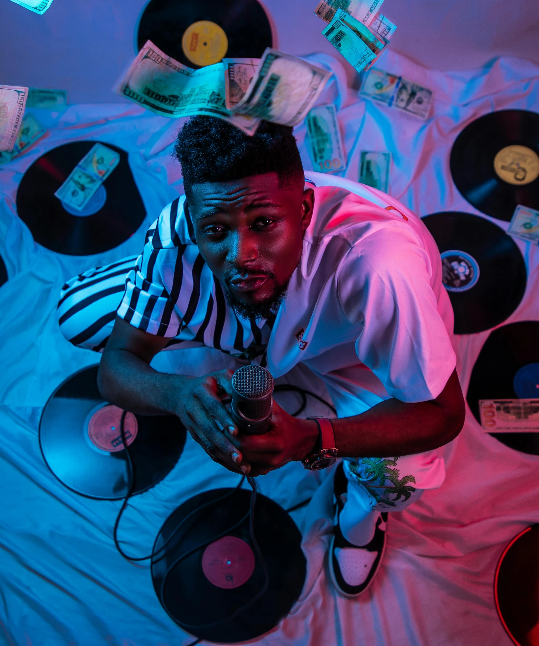 a man holding a record player while wearing headphones