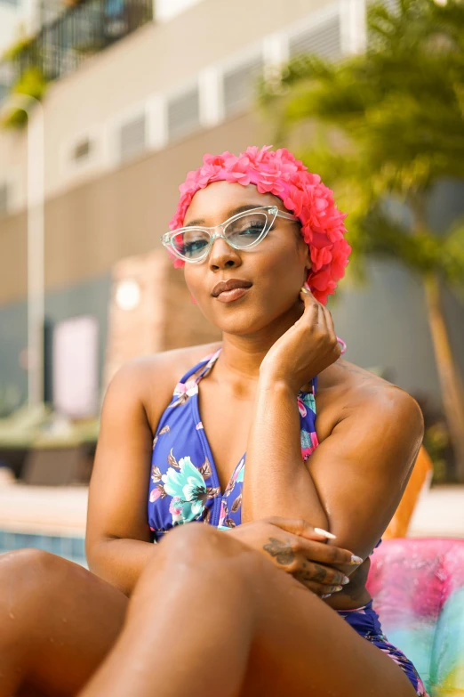 a women sitting next to a swimming pool