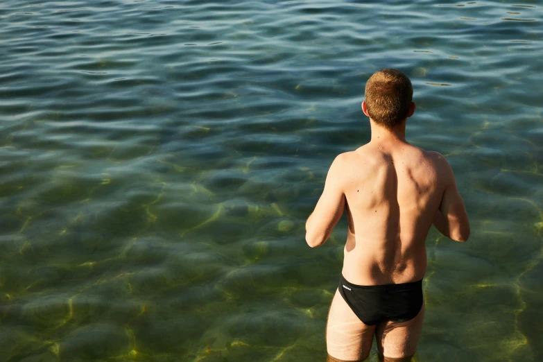 a man is standing in the water with  on