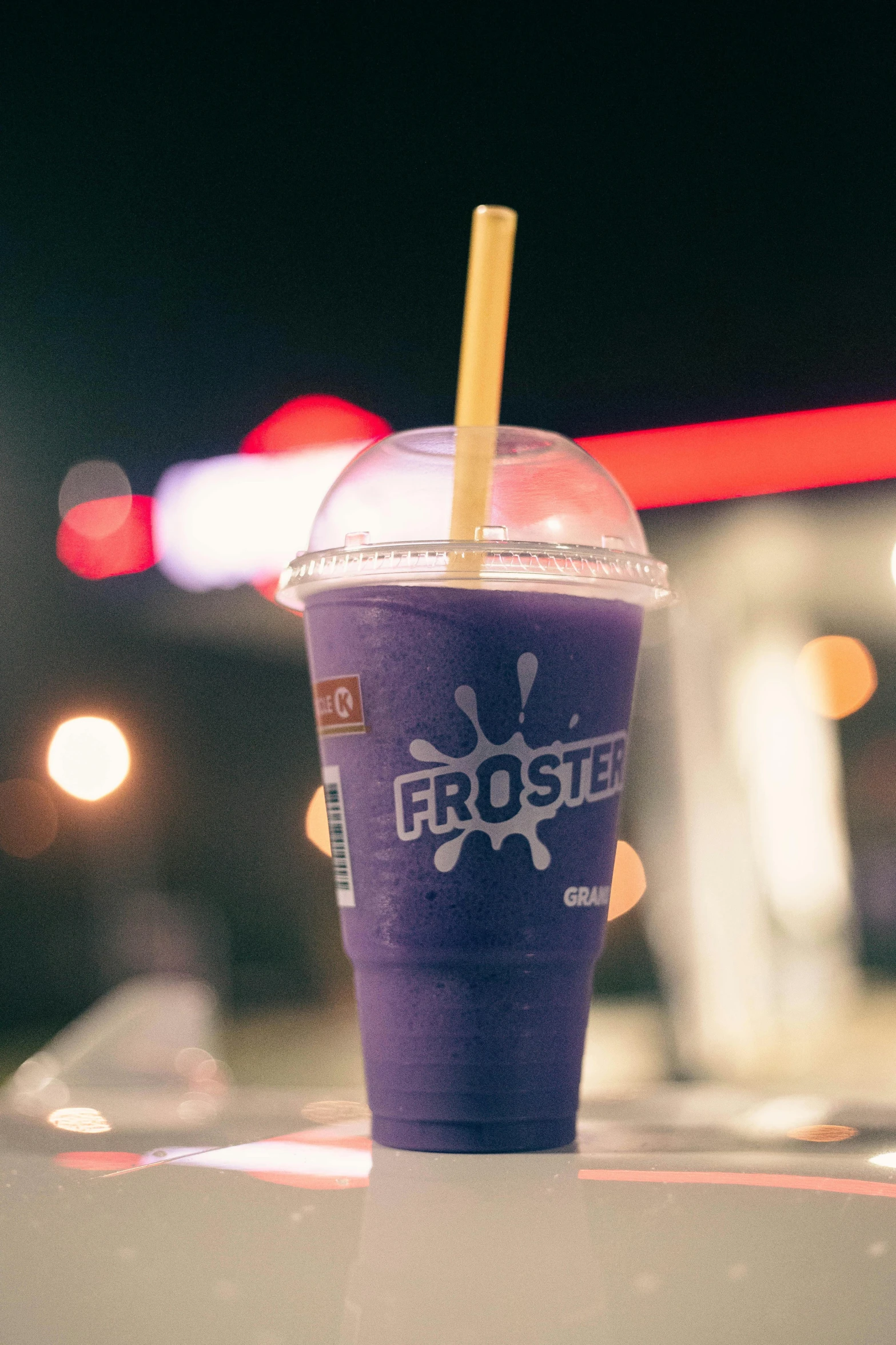 a purple drink with a straw sticking out from the top