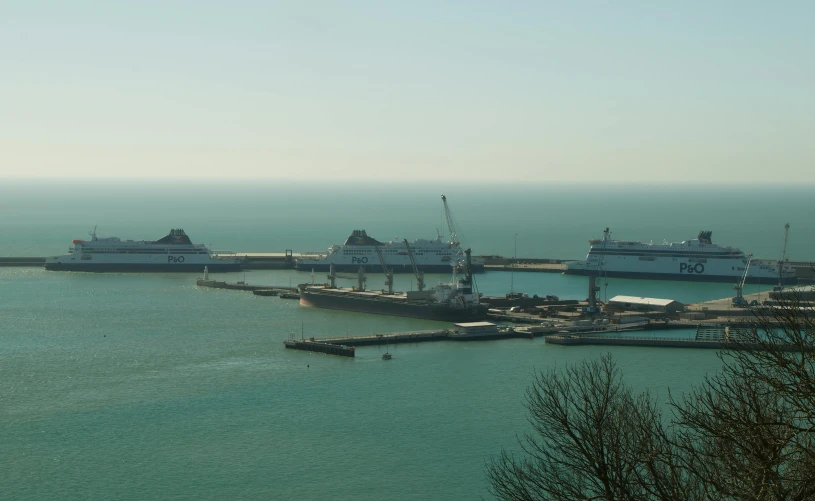 several large ships docked in a large body of water