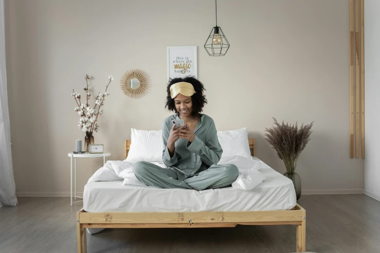 a man is sitting on his bed and wearing a yellow hair comb