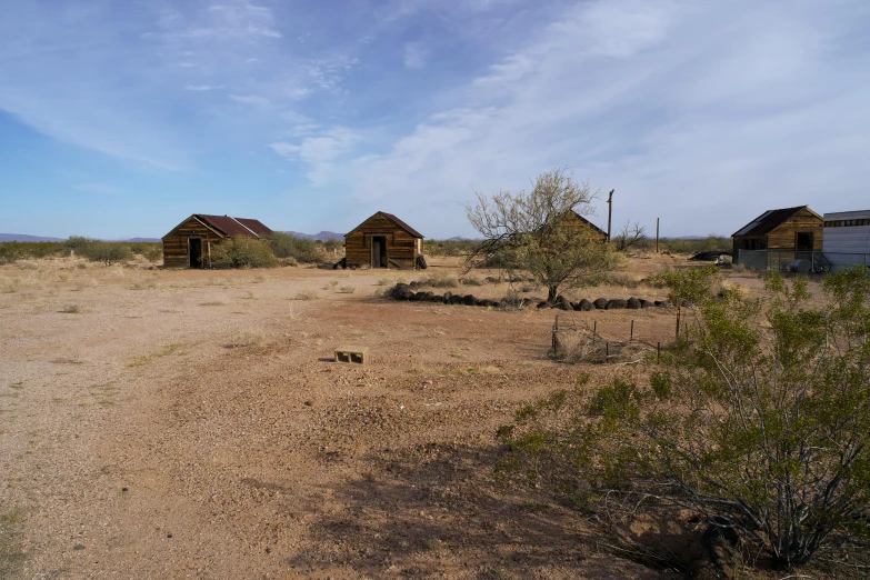 two small shack style buildings in the desert