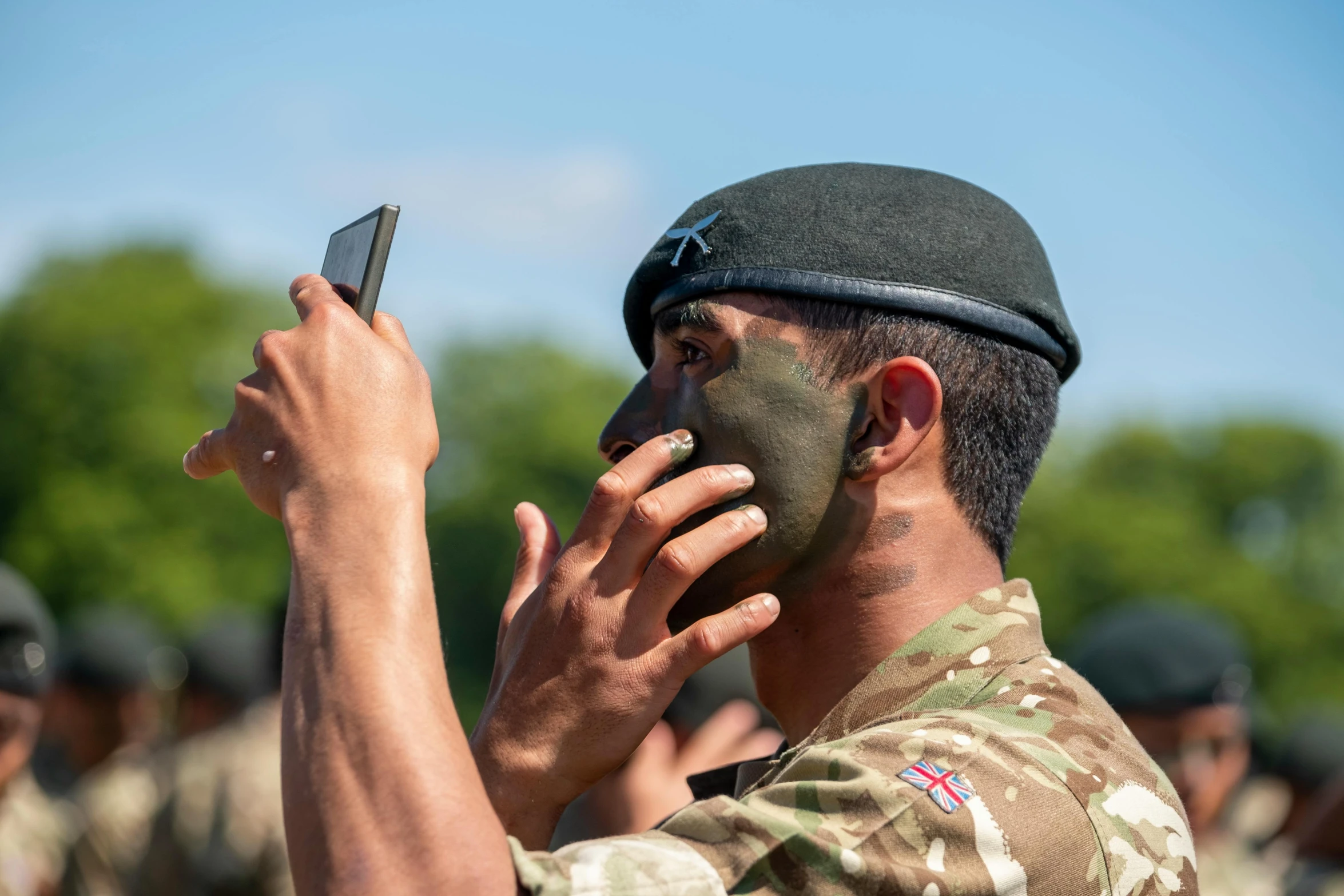 a soldier is talking on his cell phone