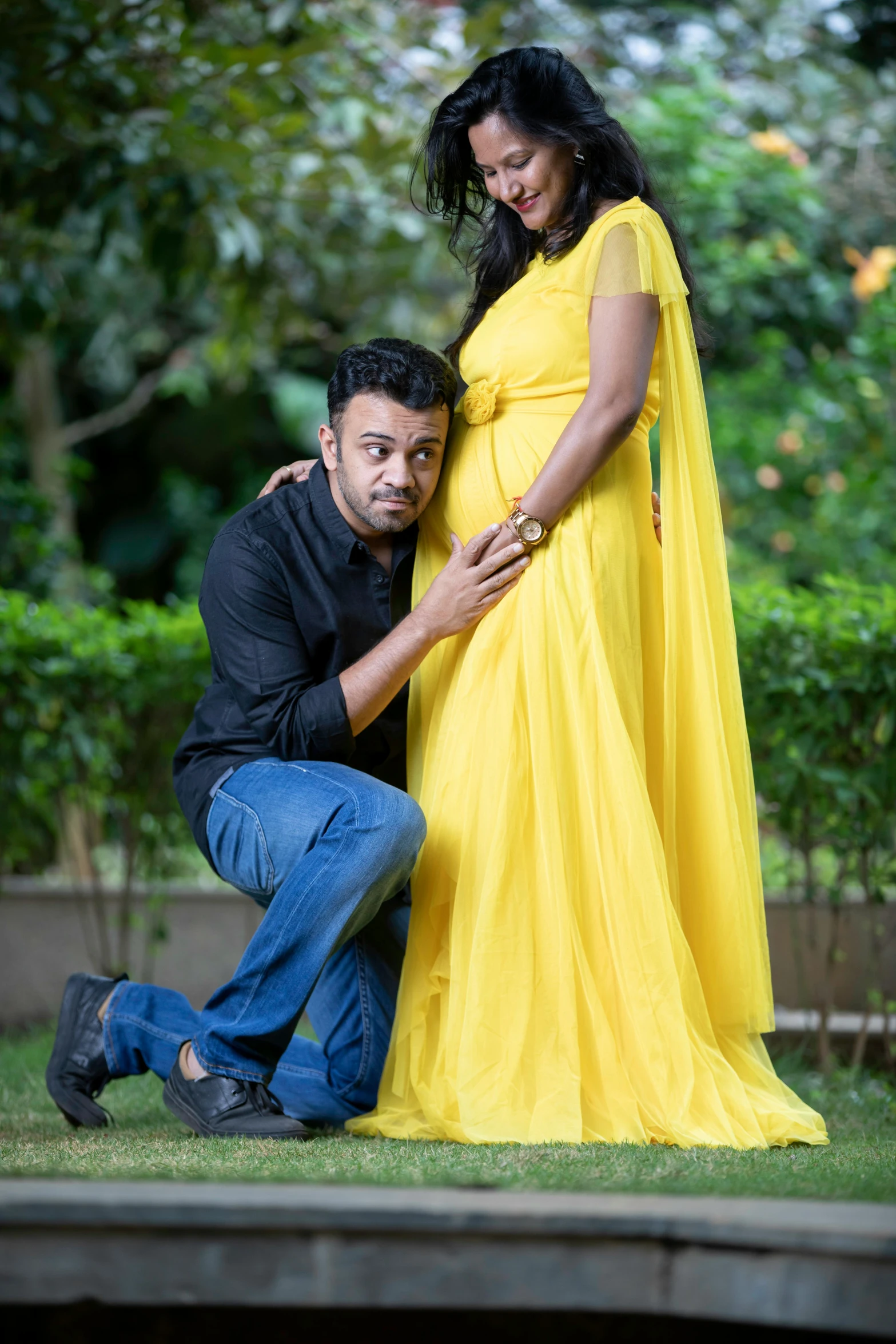 an indian couple poses for a portrait wearing yellow