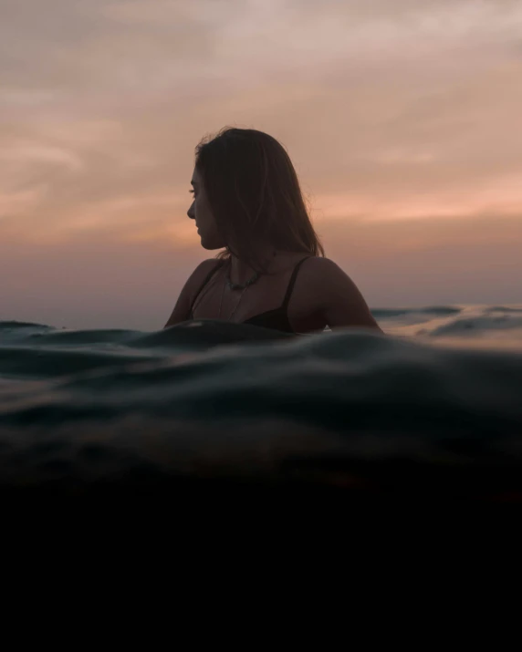 a woman is standing out in the water