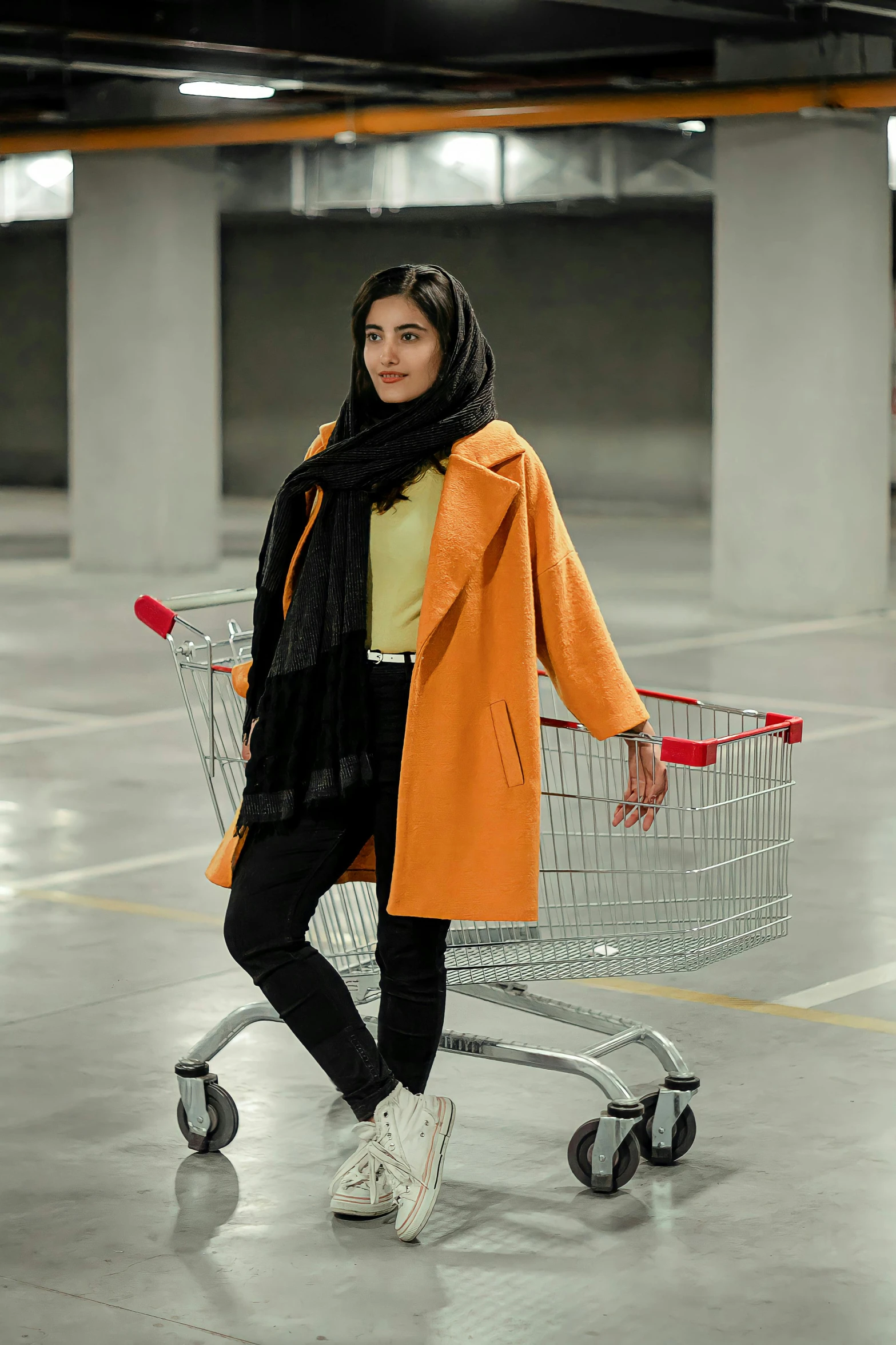 a woman is walking with a shopping cart