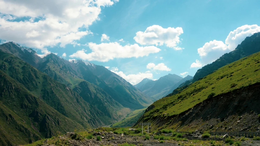 the view of a mountain valley with many tall mountains