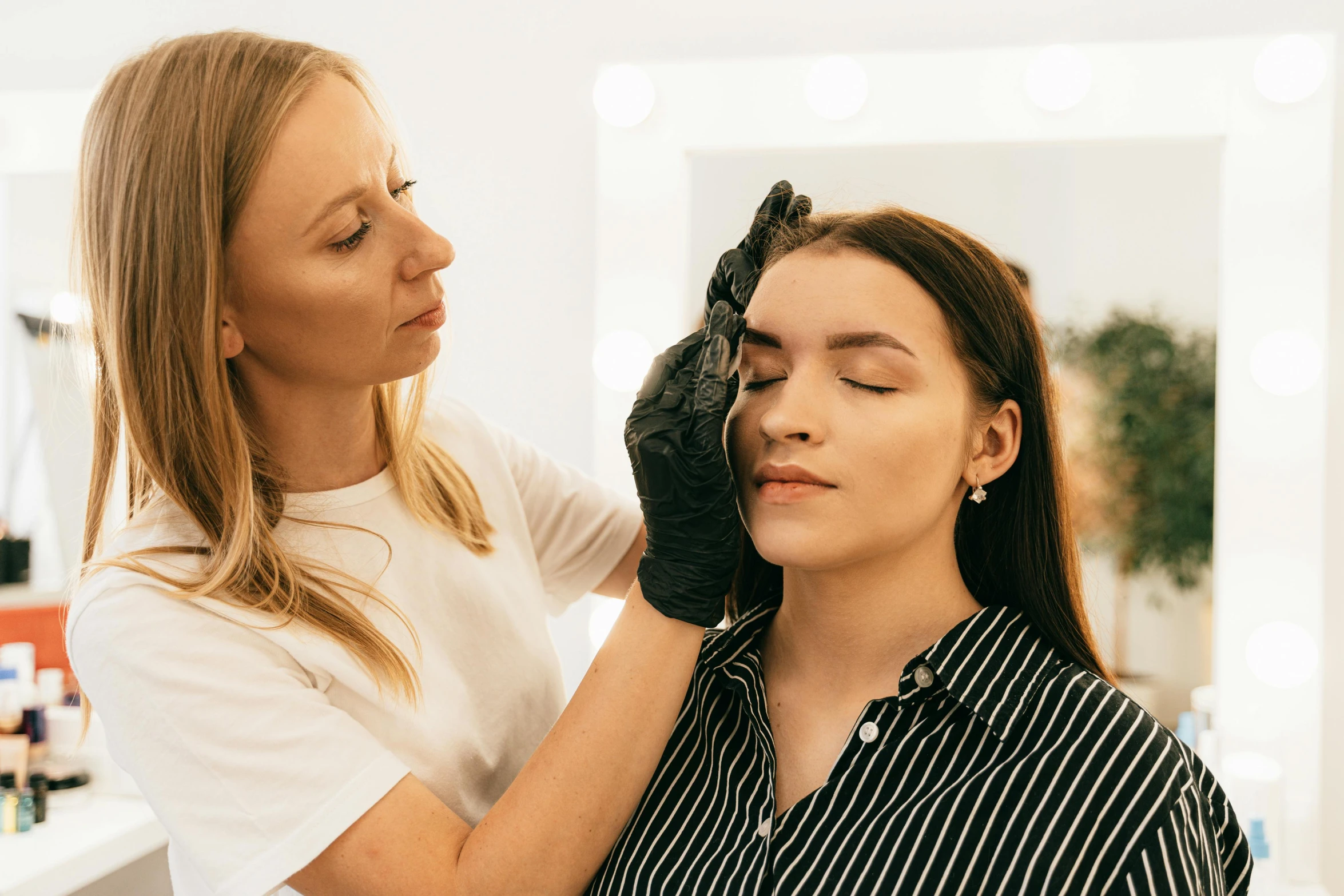 a woman getting her hair styled by a blow dryer