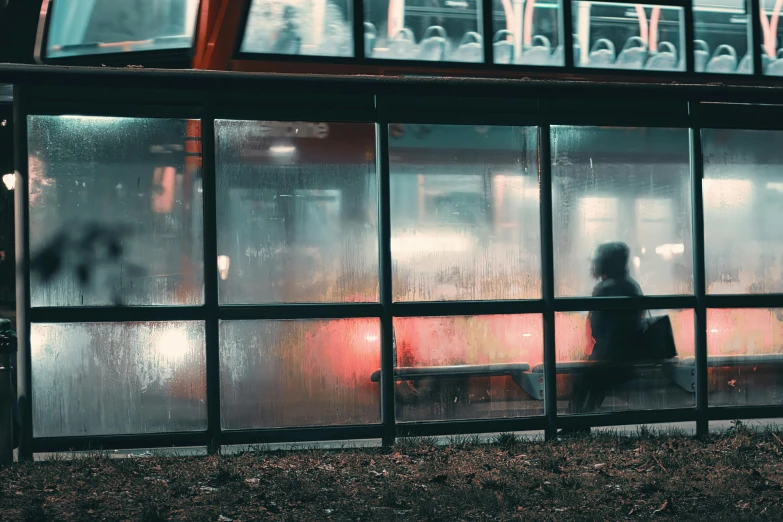 a person is sitting on a bench near a window