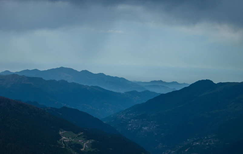 an airplane flies low in the sky on top of mountains