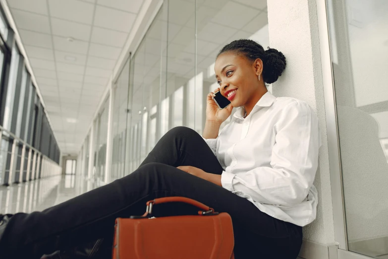 a woman sitting on the steps while using her cellphone