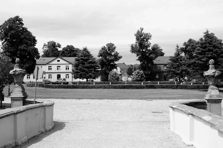 a driveway is shown with a house and garden on the side