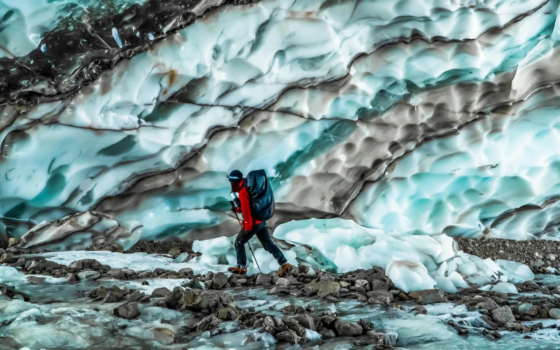 two people standing in front of a very massive ice formation