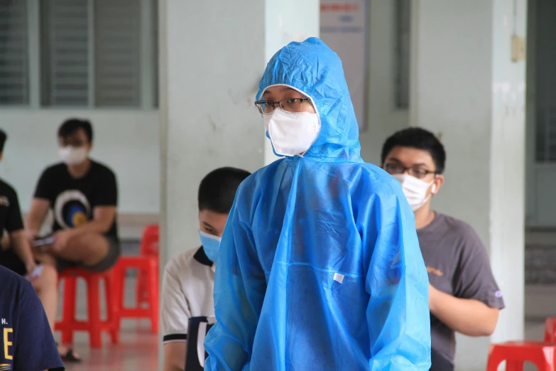 a man wearing a face mask and raincoat