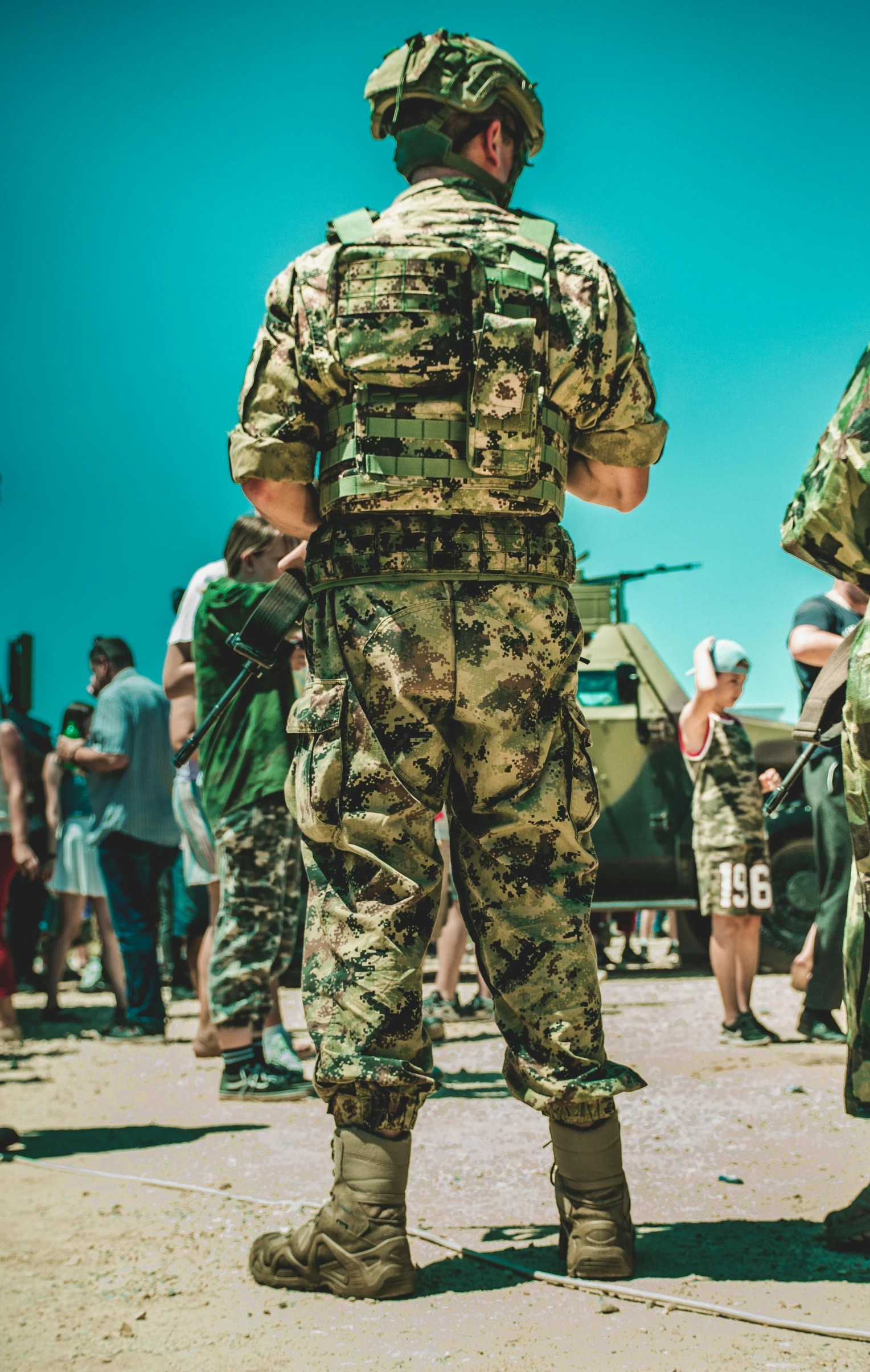 a soldier looking over to another person in uniform with others