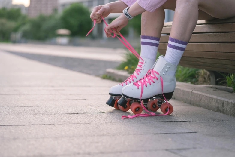 a person tying the roller skates to their skis