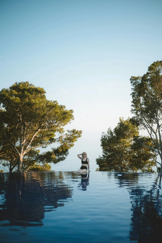 the woman is posing for her image in the pool