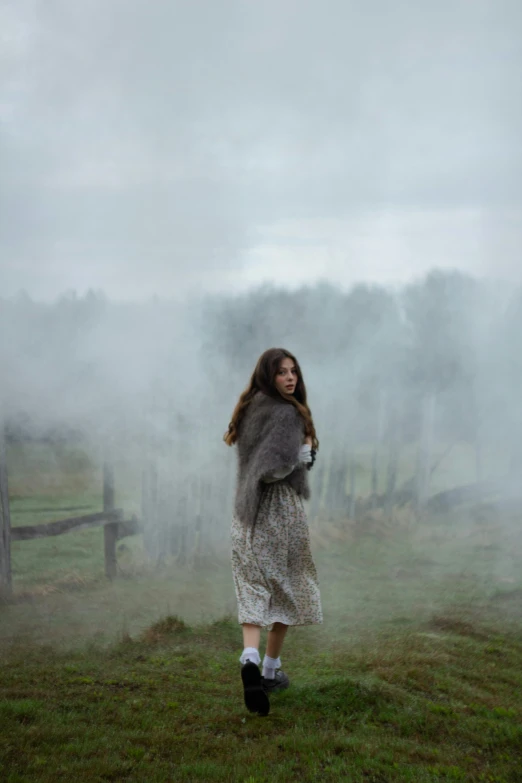 a girl standing alone in the rain