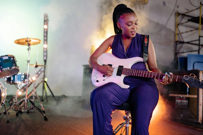 a woman on a bike with an electric guitar