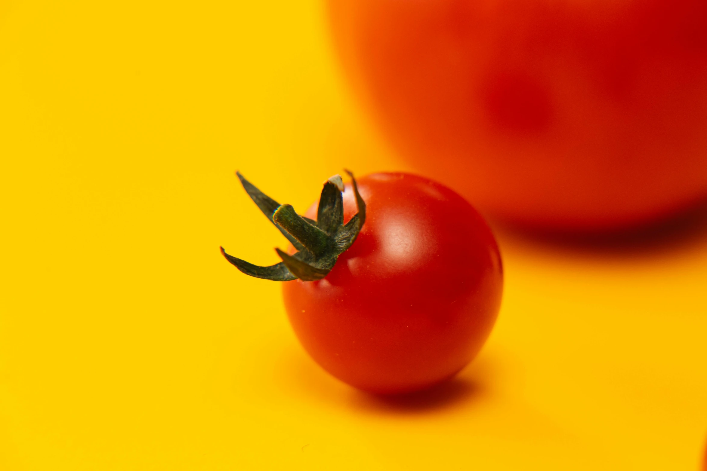 a close up s of a red tomato and an orange background