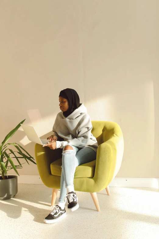 there is a woman sitting in a chair reading a book