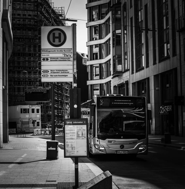 a large bus drives through a downtown intersection