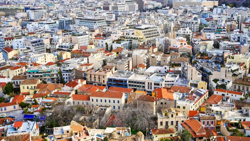 a view of the city from above on top of a hill