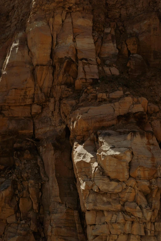 a man on an airplane flying over a rocky mountain