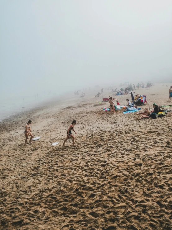 a beach with many people playing around