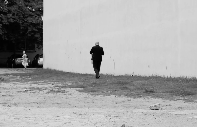 a person standing in front of a building looking at another person