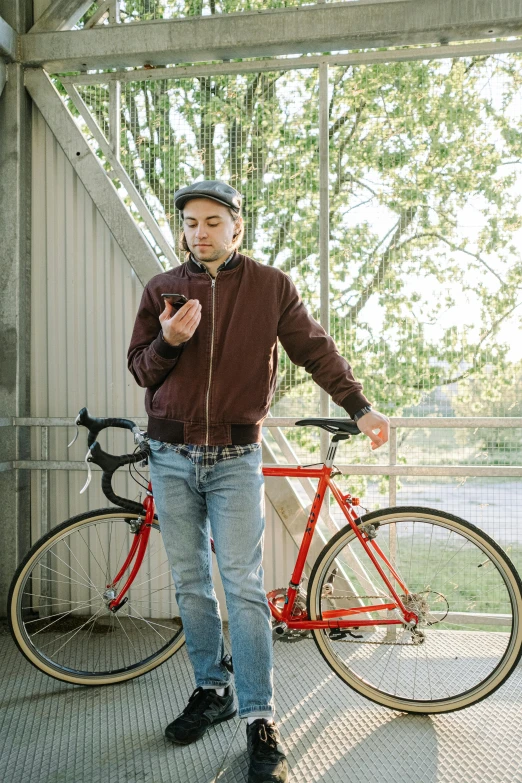 a man standing with his bicycle near some stairs