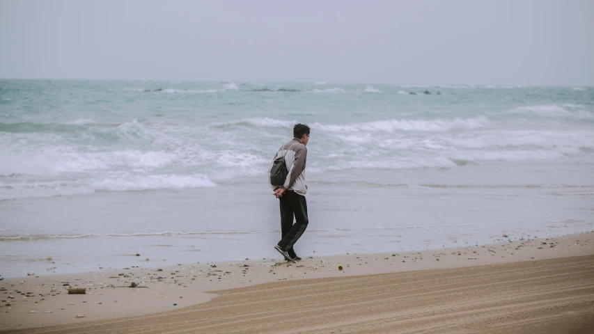 a man looking out to the ocean standing in front of an ocean