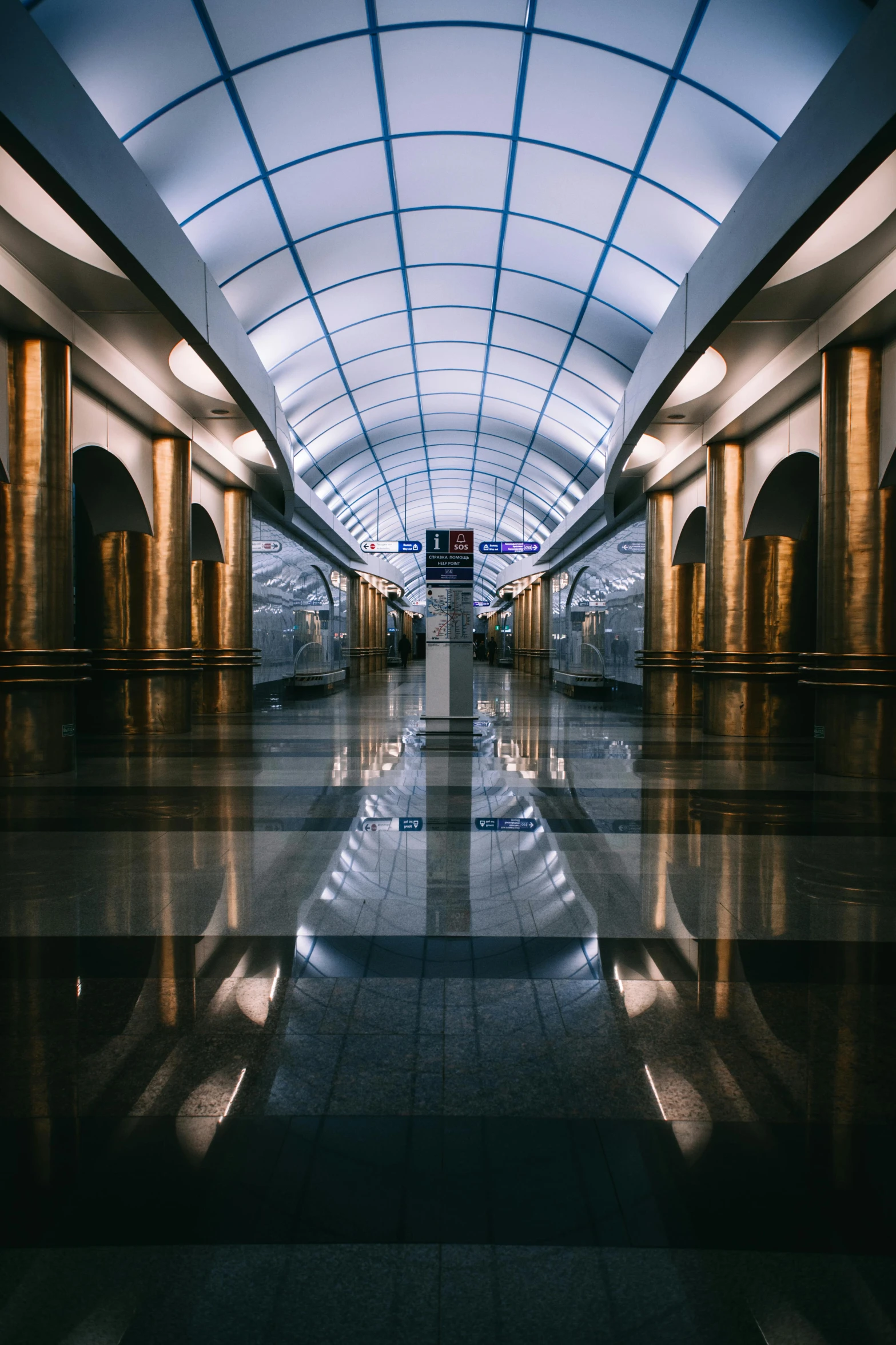 a long walkway in the middle of a large building