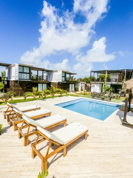 an empty pool is next to lounge chairs