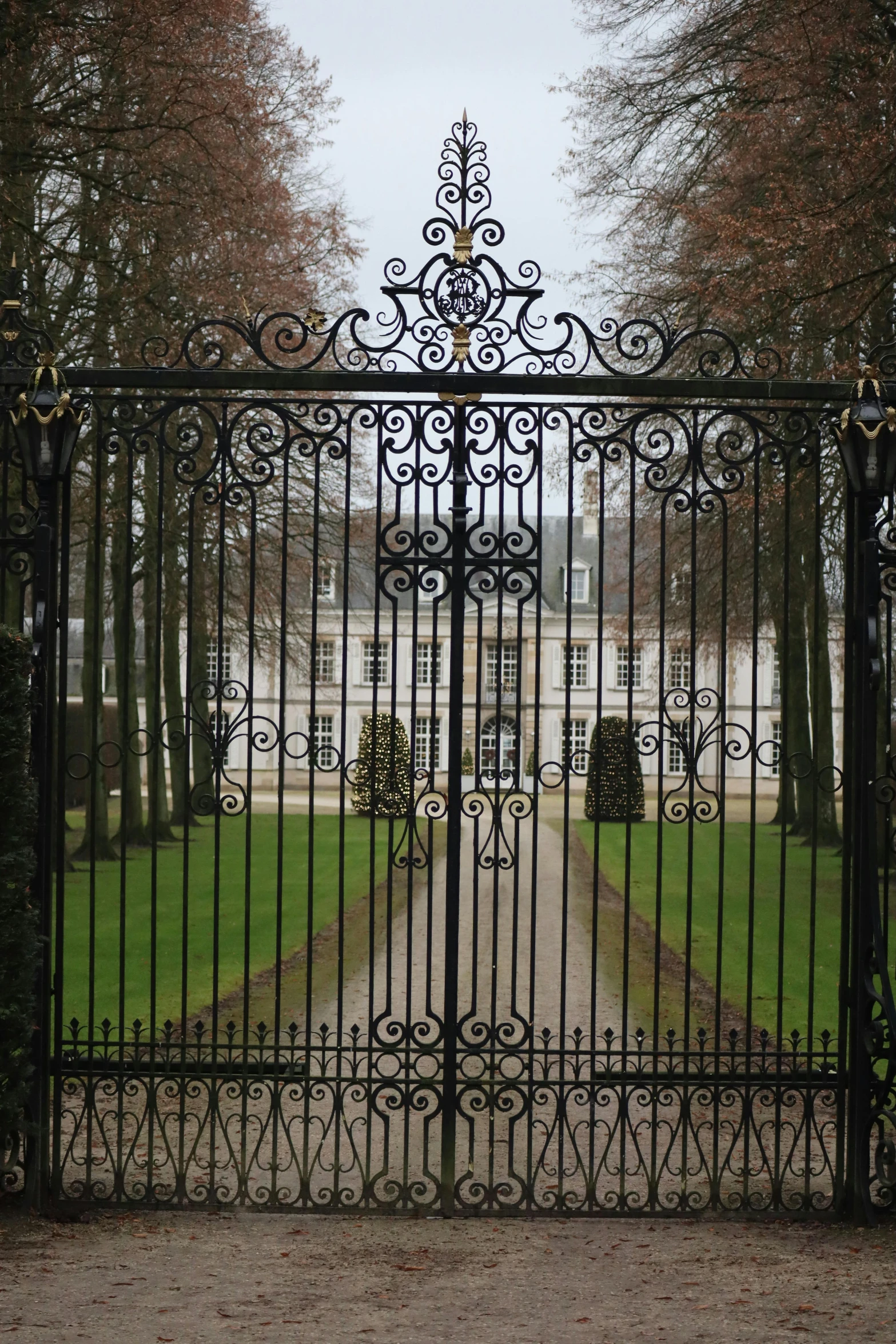 the gates to an area with the trees behind it