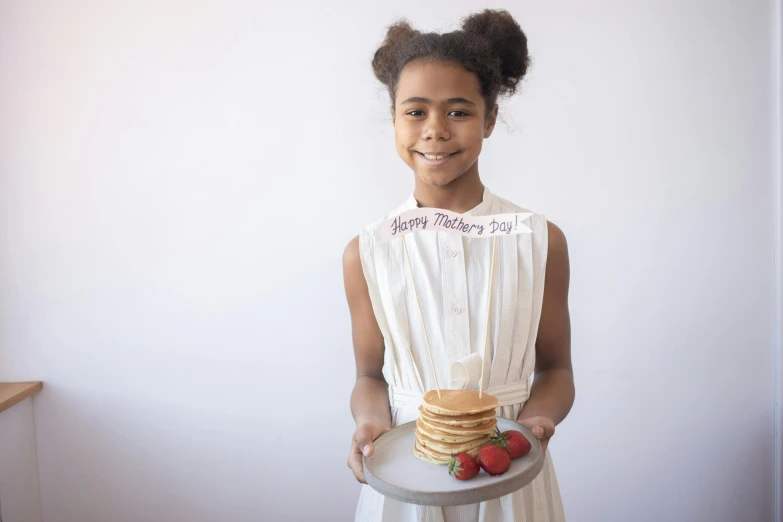 a woman holding a platter full of food