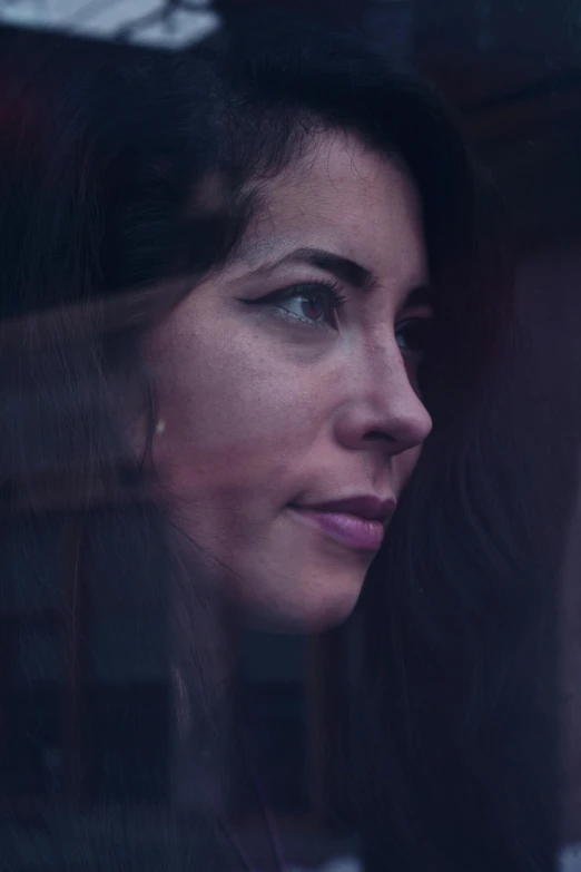 woman looking out window with focus on her face