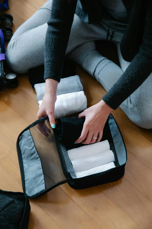 someone is holding onto a rolling travel bag