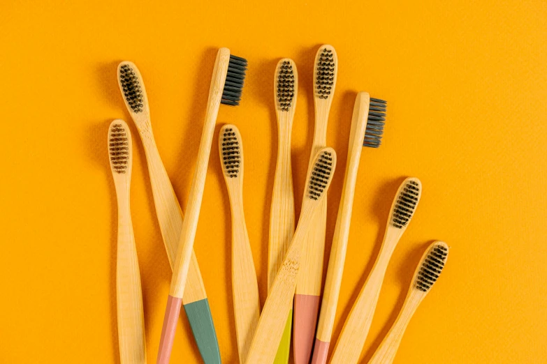 a bunch of bamboo toothbrushes with different types of bristles