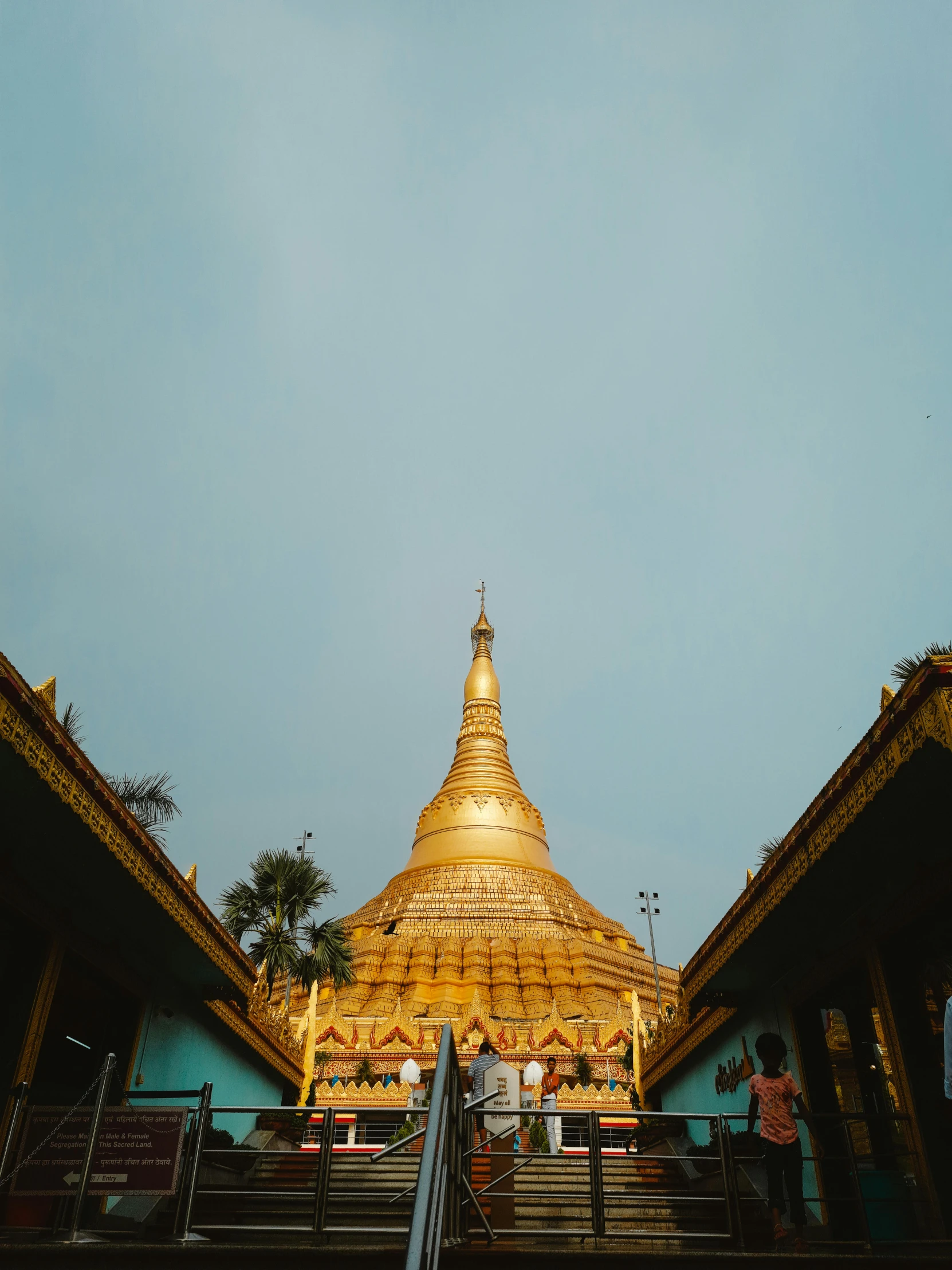 the steps lead up to a very big golden pagoda