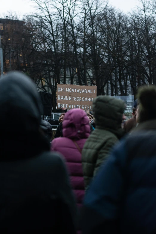 some people walking down the street with a sign