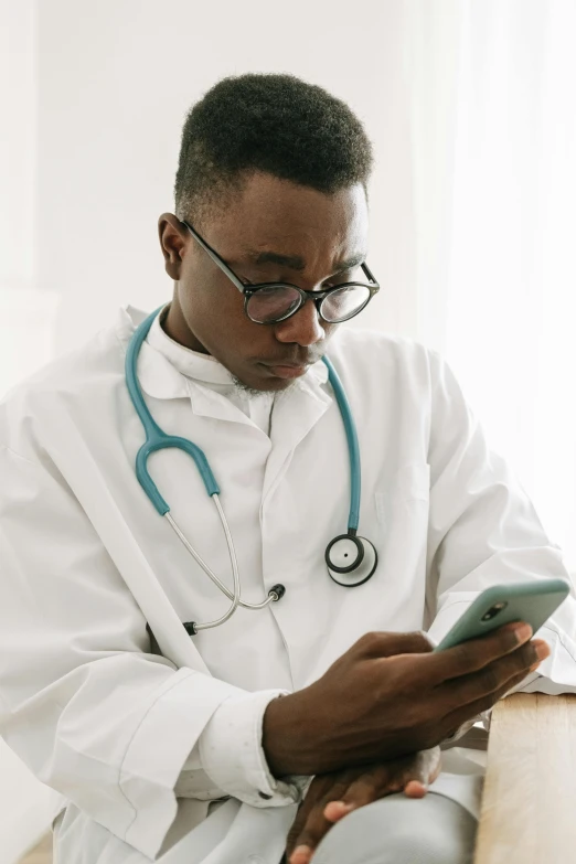 a doctor checking his medical record on his phone