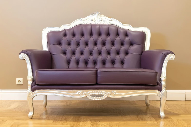 the couch is purple and white with intricate details