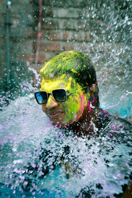 a man has fun in the water with his face and body painted